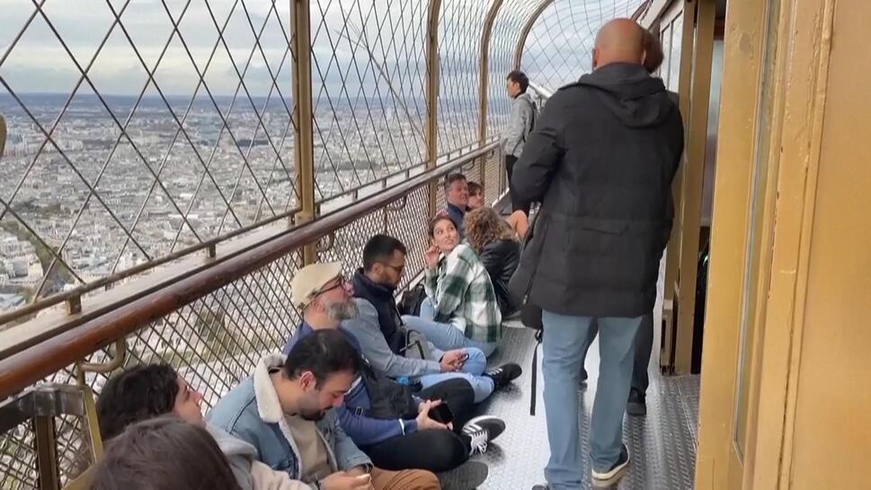 Stranded tourists sit at top of Eiffel Tower overlooking Paris