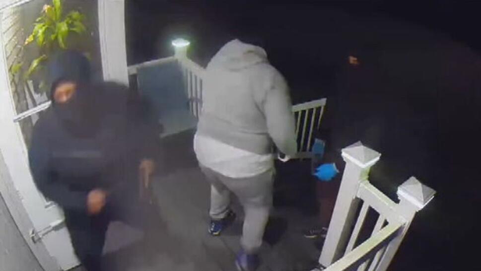 3 masked gunman trying to kick down the door to a home