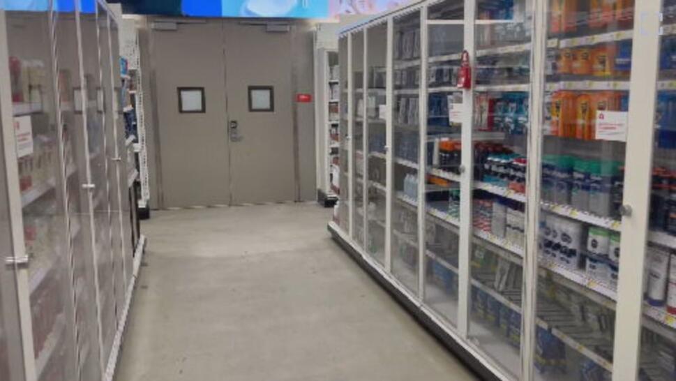 aisle of store with items locked away
