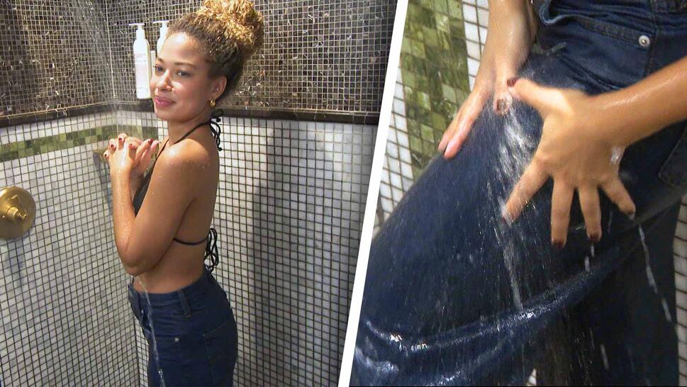 Woman in shower wearing jeans / close up of scrubbing jeans