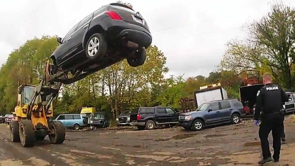 Car thief trapped in the air by a forklift.