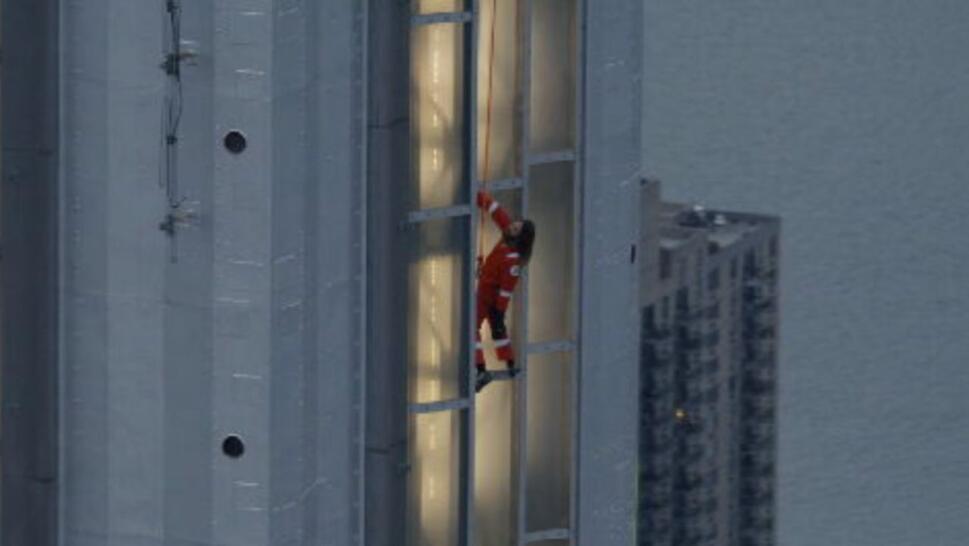 Jared Leto in orange jumpsuit climbing Empire State Building
