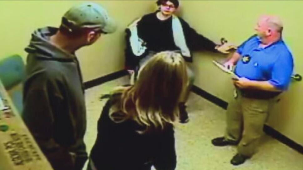Ethan Crumbley sitting on chair handcuffed to wall talking to his parents Jennifer and James
