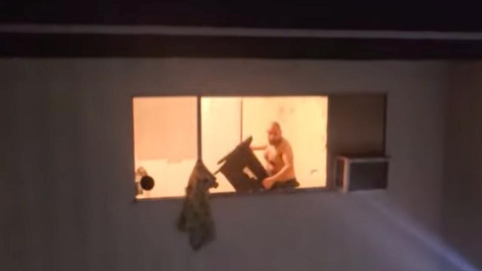 man throwing chair out of window