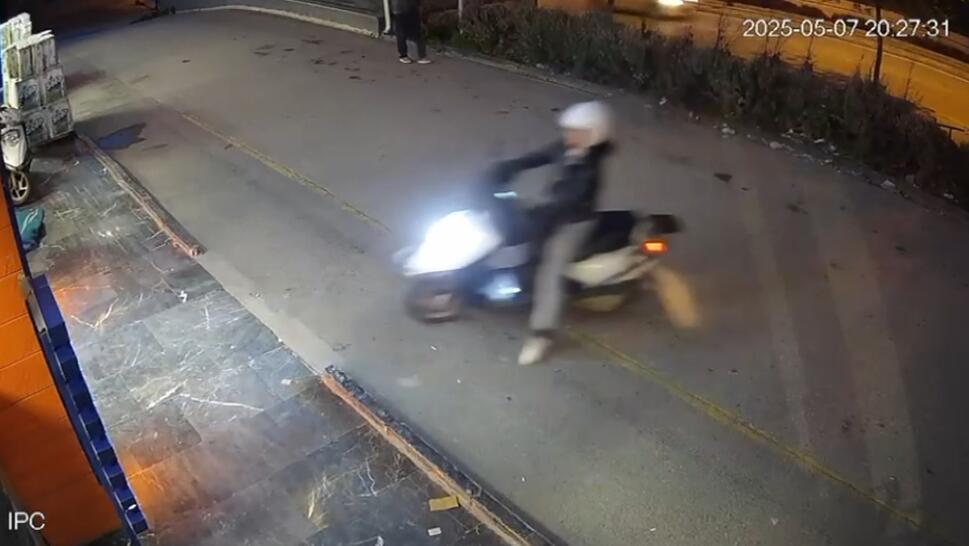 Moped Before it Accelerates Through Pet Store Glass Window
