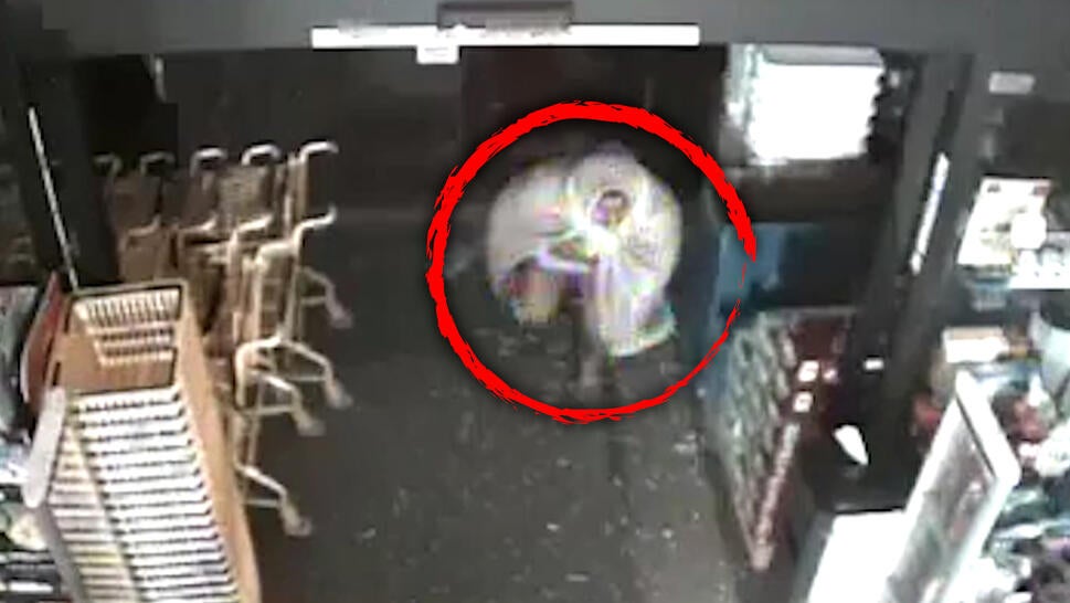 Man entering store wearing blanket