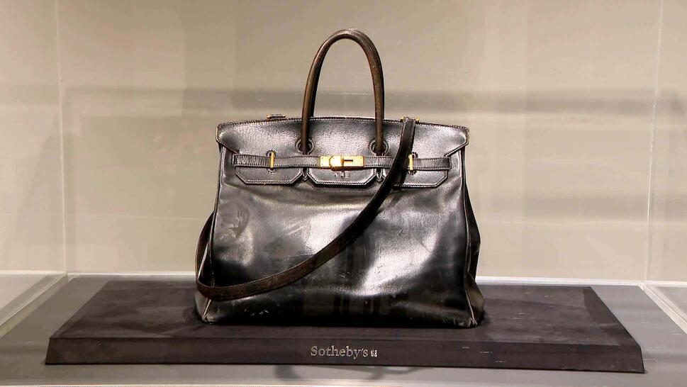 Birkin bag inside of a glass display case