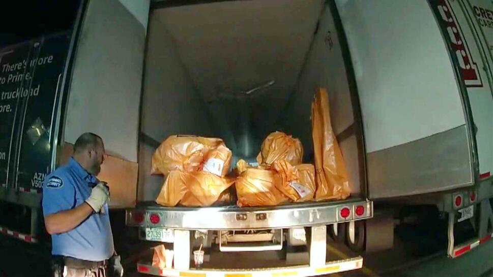 Open backend of a box truck filled with bags