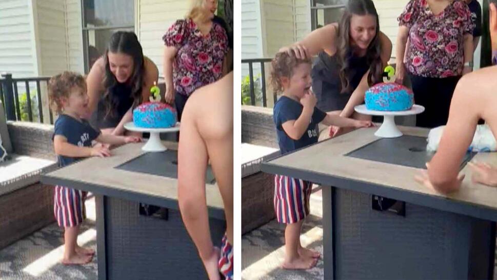 Photo of a child preparing to blow out birthday candles on a cake