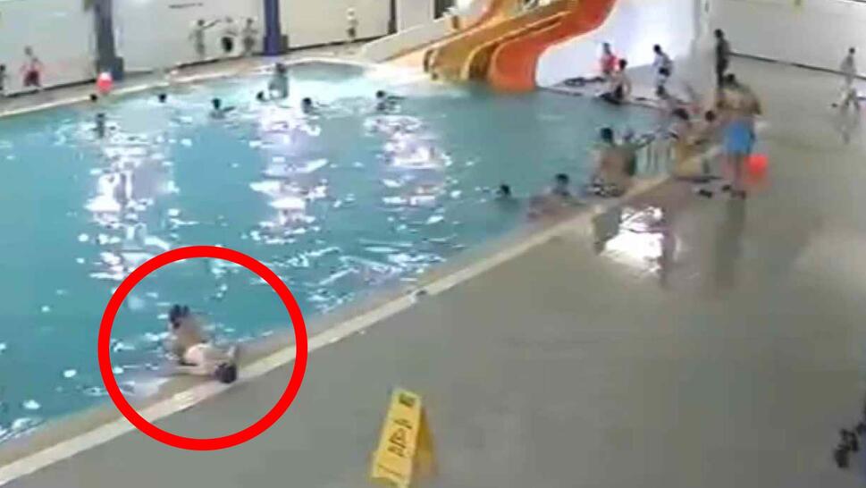 Man saving child from drowning in pool