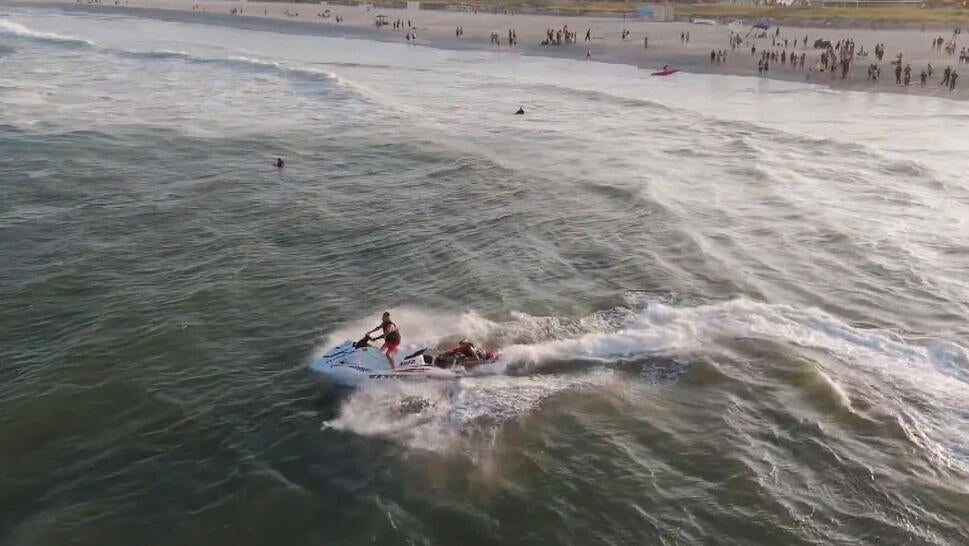 First responders on jetski rushing out into ocean