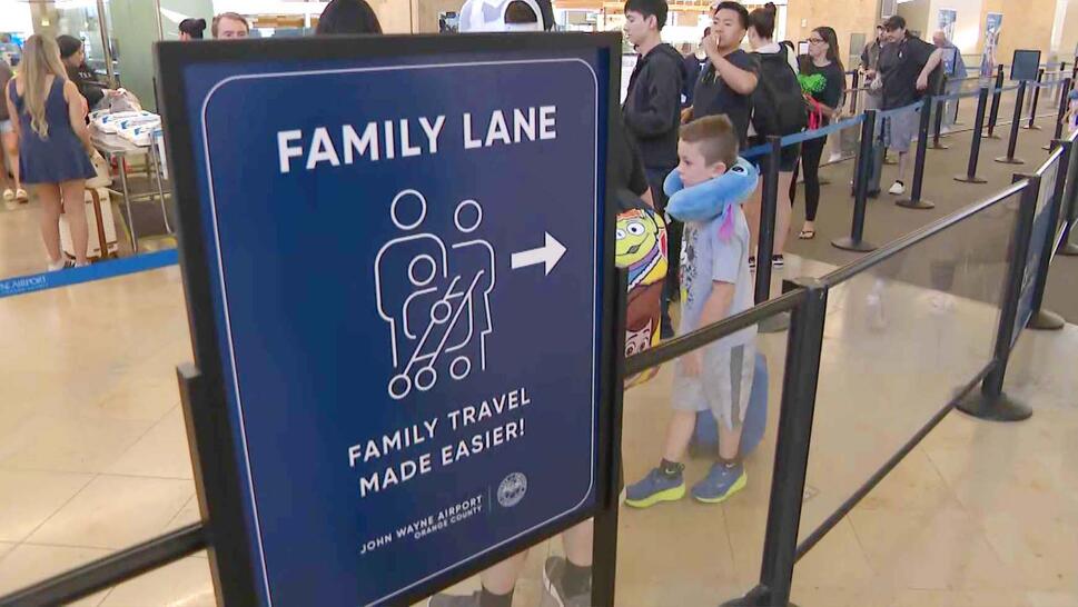Sign posted near airport security line reading 'Family Lane'
