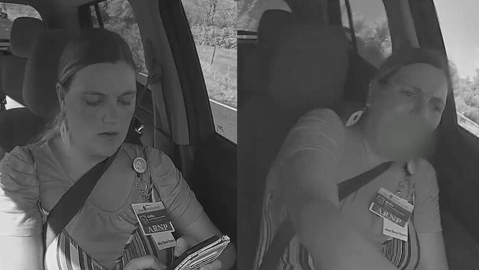 Woman texting while driving, trying to control the steering wheel