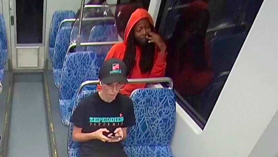 Woman sitting on a bus texting with a man in a red hoodie sitting behind her
