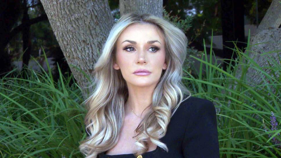 Courtney Stodden standing outside and looking off into the distance wearing a black blazer