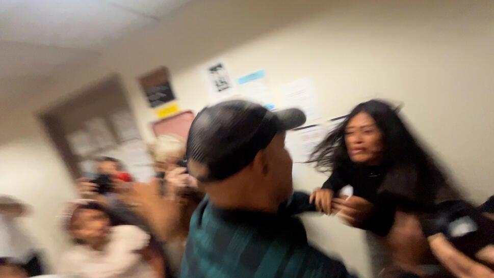 Man pushes woman in hallway