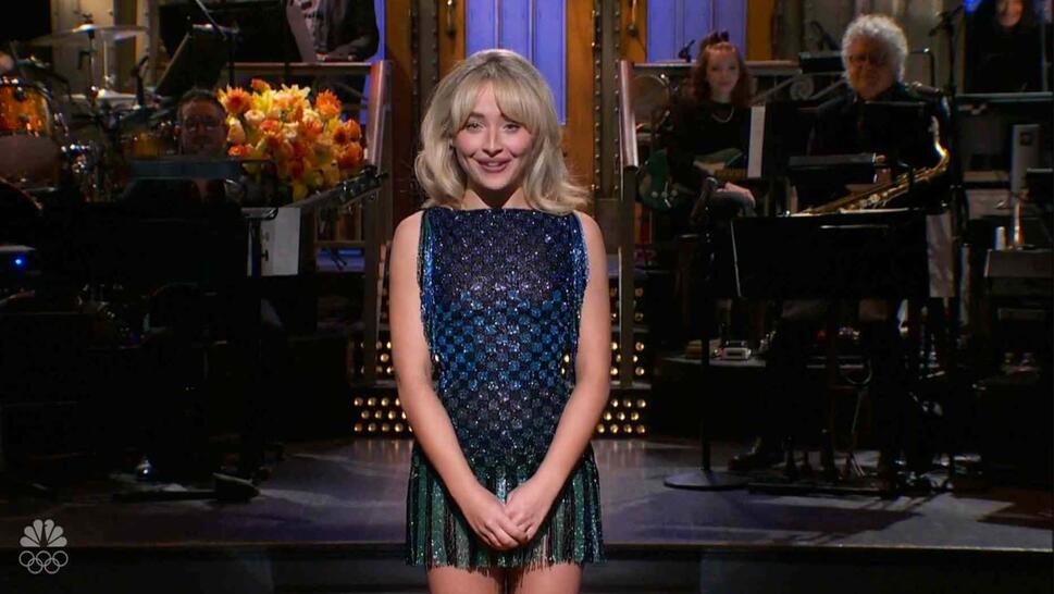 Sabrina Carpenter standing on stage hosting SNL