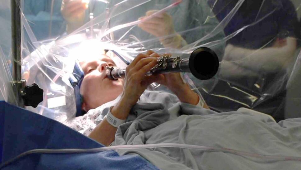 Patient playing clarinet during surgery