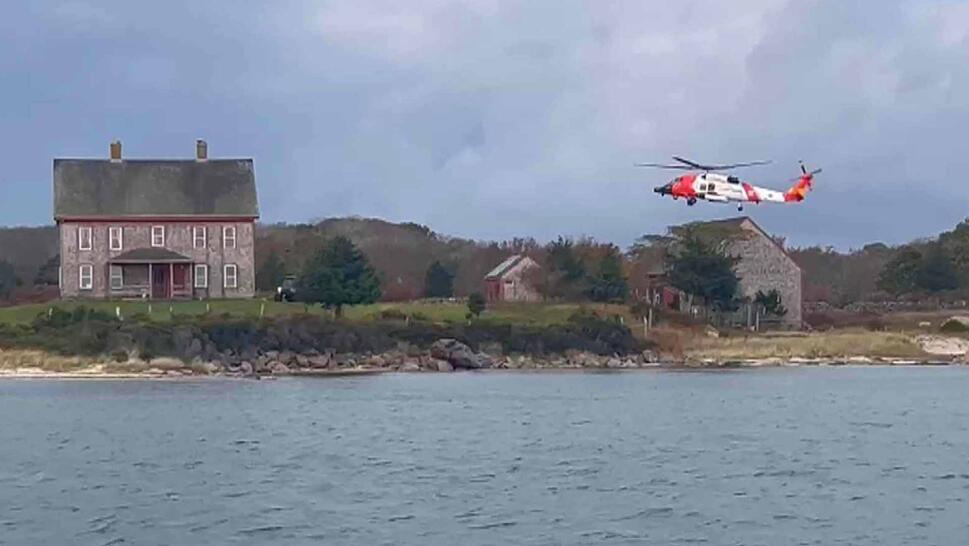 Medical helicopter flying over cottage on an island