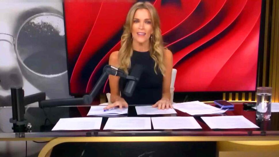 Megyn Kelly sitting at her desk speaking into a microphone