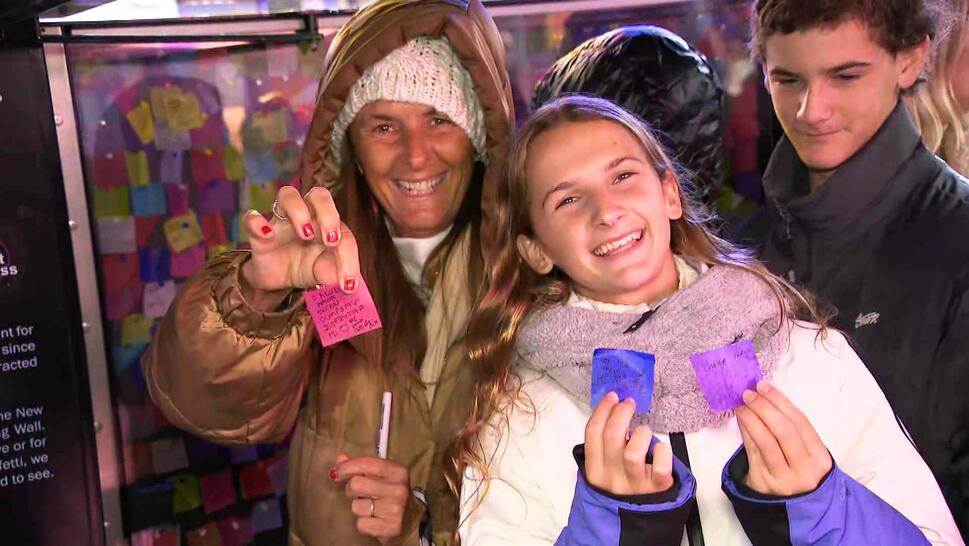 Mother and daughter holding up the confetti they wrote wishes on 