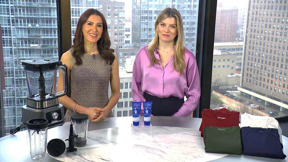 Two women standing behind a table displaying a Blender, Hand Lotion, Thermal Set