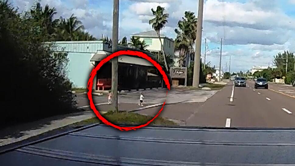 Surveillance footage of two children on a road, within a red circle