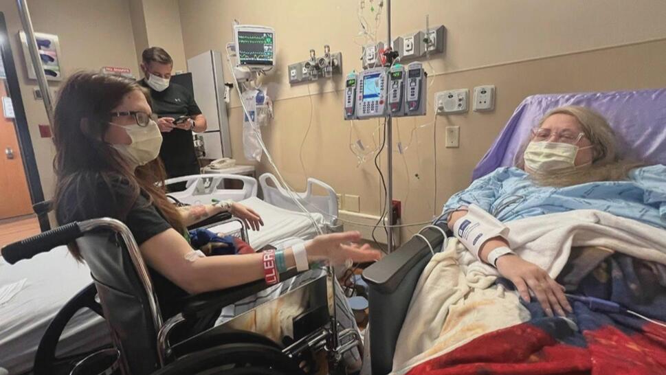 Woman in hospital bed, another woman in wheelchair next to her