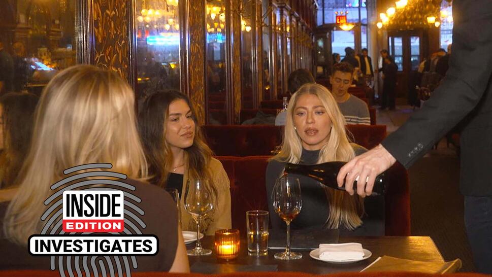 Group of women sitting at a restaurant table as wine is poured into their glasses