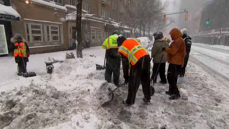 Shovelers Help Clear Snowy Streets 