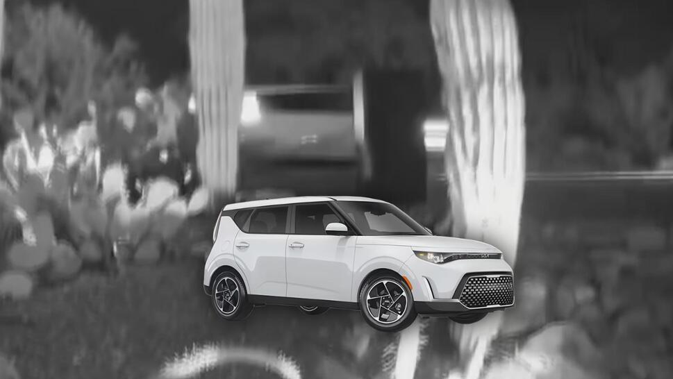 Home security camera footage of an obscured view of a car, possibly a KIA Soul (pictured below the video image)