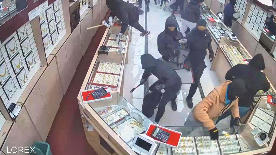 Multiple thieves charging into a jewelry store