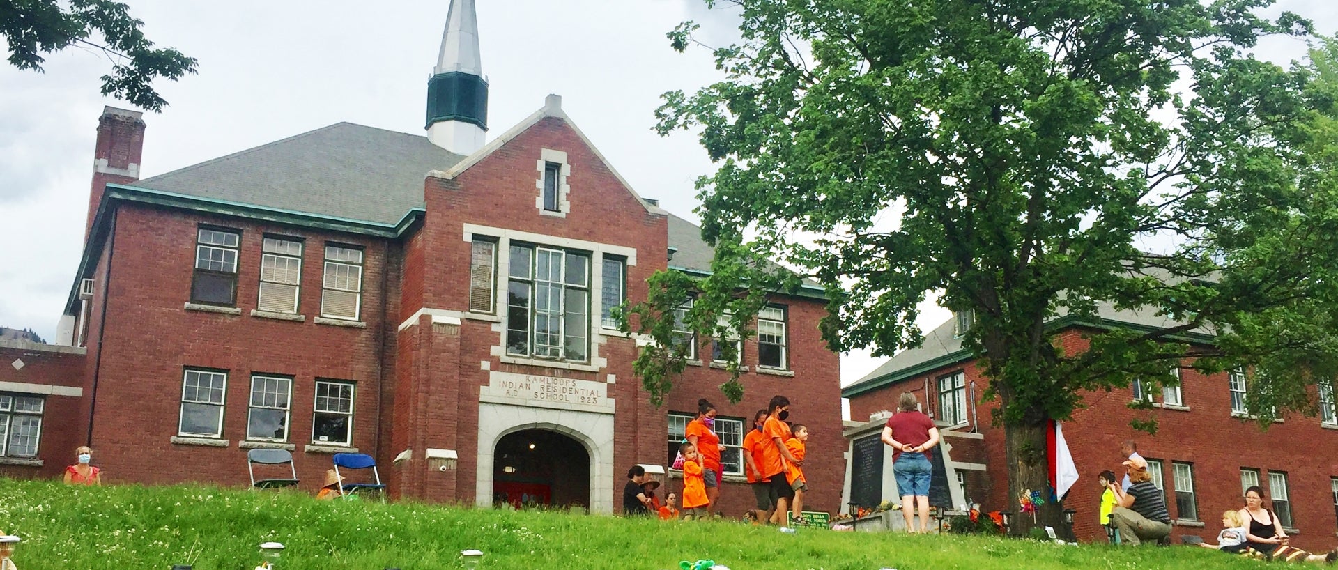 Stuffed animals were placed in front of the former Kamloops Residential School Monday in a community vigil that encouraged attendees to wear orange, a Canadian tradition that aims to raise awareness for the atrocities of residential schools.
