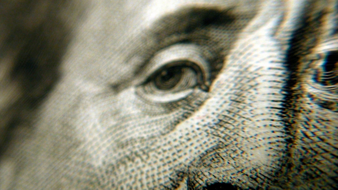 Close up of Benjamin Franklin's eyes and nose on currency.