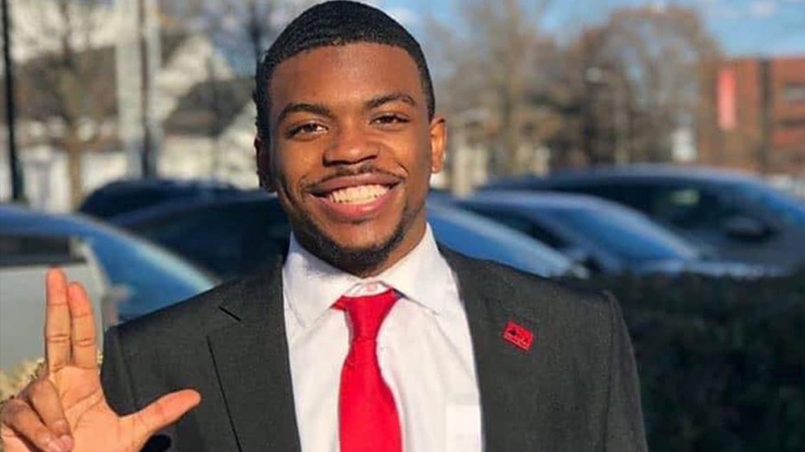 Photo of missing Quintez Brown smiling with suit and tie on
