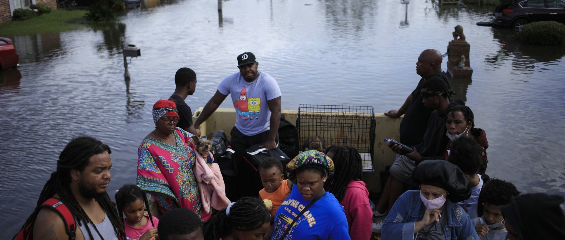 Residents ride in a high water vehicle after being rescued from floodwater left behind by Hurricane Ida in LaPlace, Louisiana, U.S., on Monday, Aug. 30, 2021.