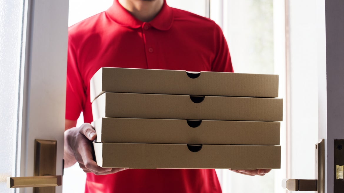 A man delivers pizzas. 