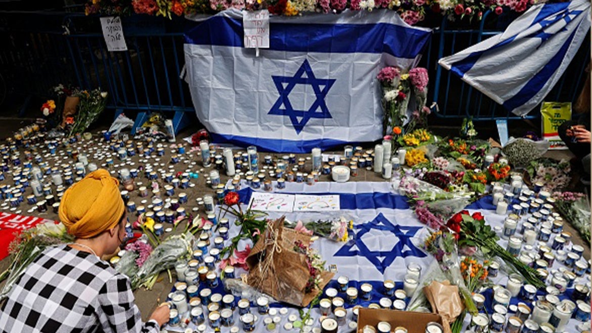 Mourners placing candles and flowers a day after a terrorist attack in Tel Aviv.