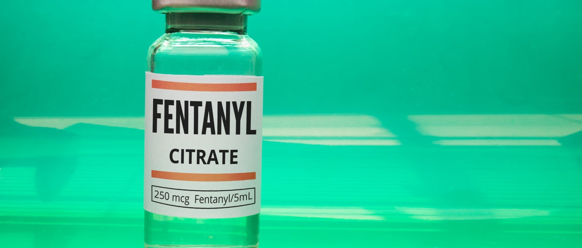 Fentanyl vial on green background