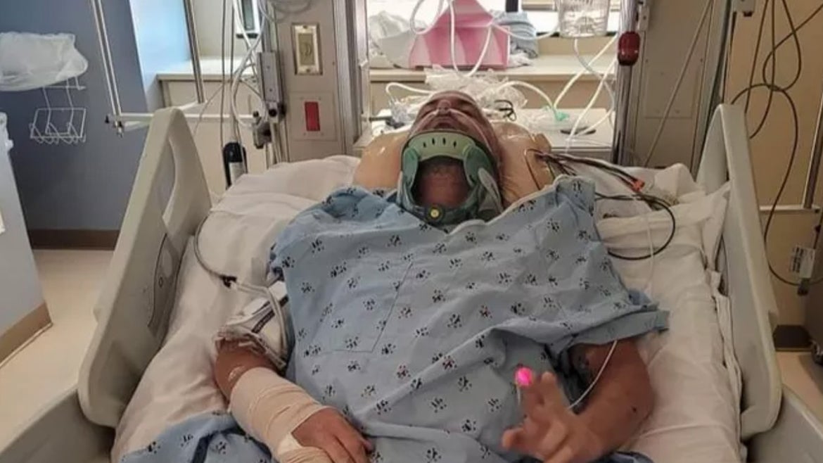 Roden seen in hospital bed with neck brace