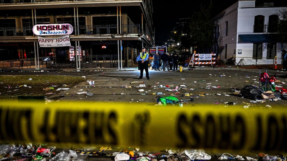Police officers work at the scene of a shooting that occured during the Krewe of Bacchus parade in New Orleans, February 19, 2023